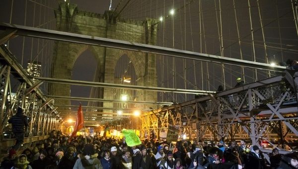 Protesters occupy the Brooklyn Bridge that connects Brooklyn to Manhattan, during a demonstration after the killing of Eric Garner.