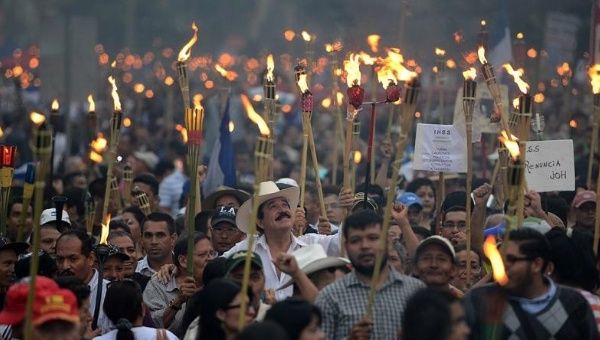 Former Honduran president Manuel Zelaya, centre, leads a march demanding President Juan Orlando resign and the government be investigated for fraud.