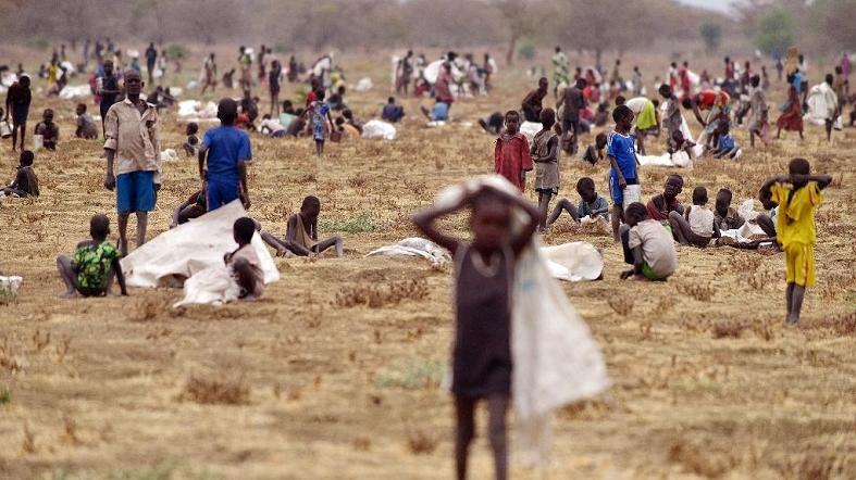Children flock with containers to a field demarcated for food-drops at a village in Nyal, an administrative hub in Unity state, south Sudan, on February 24, 2015.