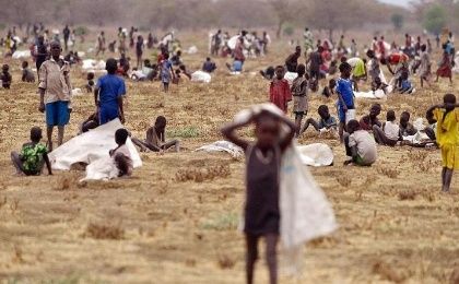 Children flock with containers to a field demarcated for food-drops at a village in Nyal, an administrative hub in Unity state, south Sudan, on February 24, 2015.