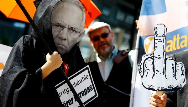 A demonstrator wearing the mask depicting German Finance Minister Wolfgang Schaeuble takes part in a protest outside the European Central Bank headquarters in Frankfurt, Germany, July 16, 2015.
