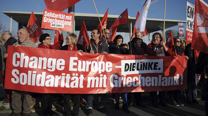 Supporters of Die Linke party (The Left) demonstrate in front of the Federal Chancellery, in Berlin, Germany, March 23, 2015. The banner reads 