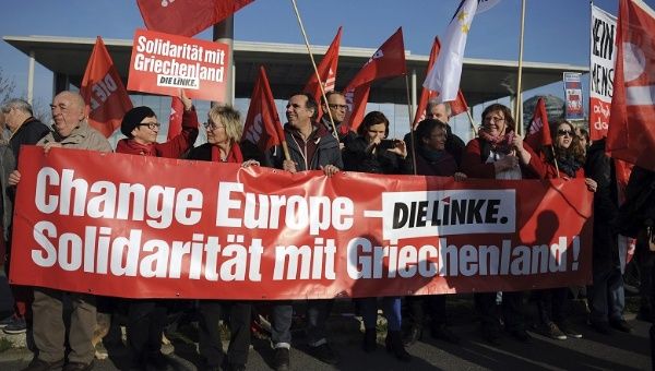 Supporters of Die Linke party (The Left) demonstrate in front of the Federal Chancellery, in Berlin, Germany, March 23, 2015. The banner reads 