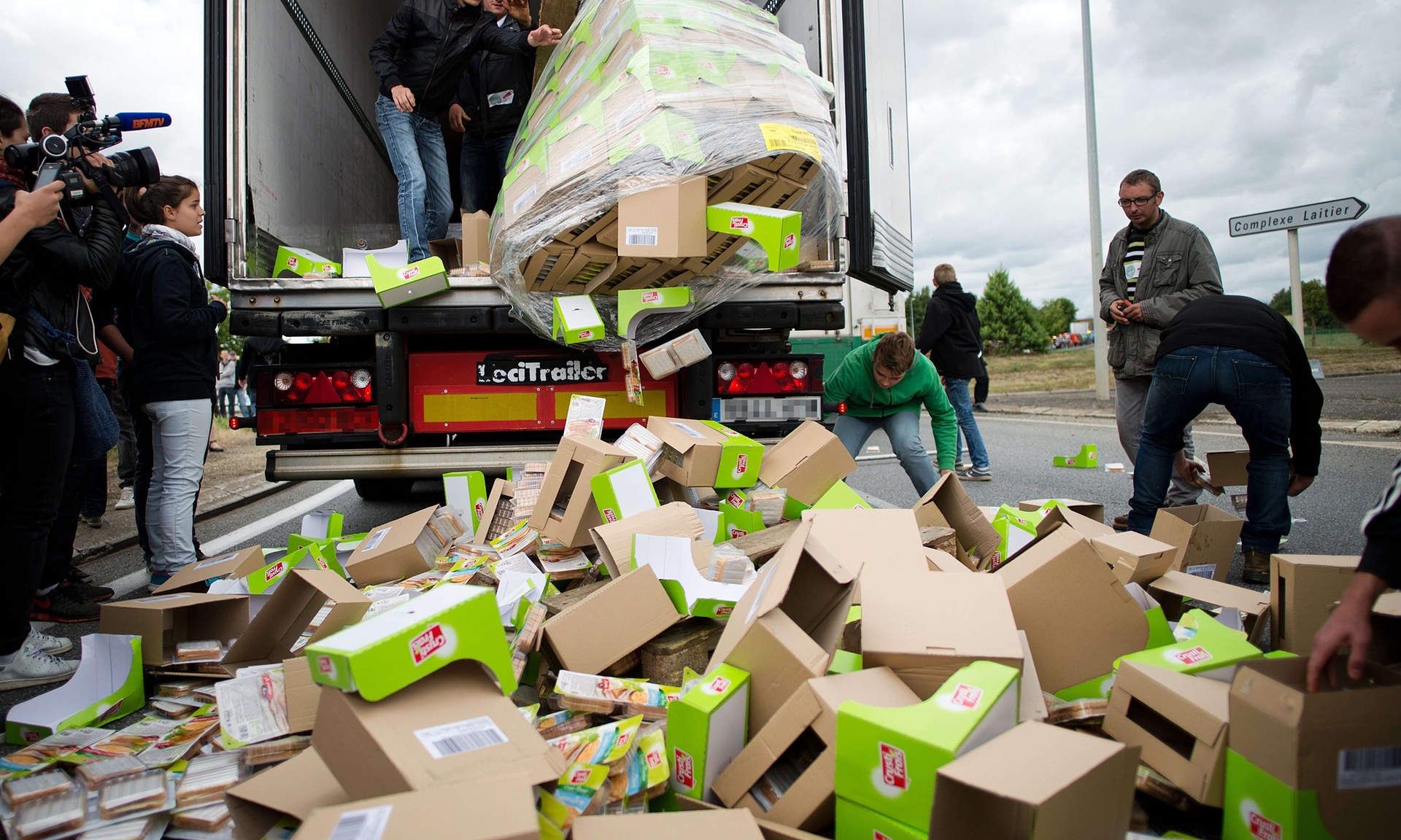 Farmers unload packages of food transported by a foreign truck in Laval, western France.