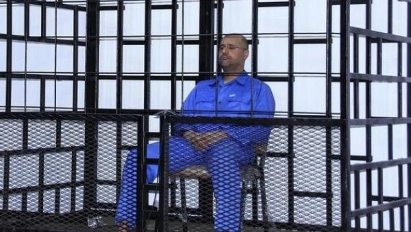 Saif al-Islam Gadhafi, son of late Libyan leader Moammar Gadhafi, attends a hearing behind bars in a courtroom in Zintan, May 25, 2014.