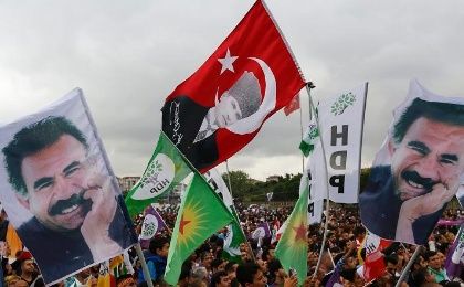 Supporters of the Pro-Kurdish Peoples' Democratic Party (HDP) wave flags with a picture the jailed Kurdish militant leader Abdullah Ocalan, during a gathering to celebrate their party's victory during the parliamentary election, in Istanbul, Turkey, June 8, 2015.
