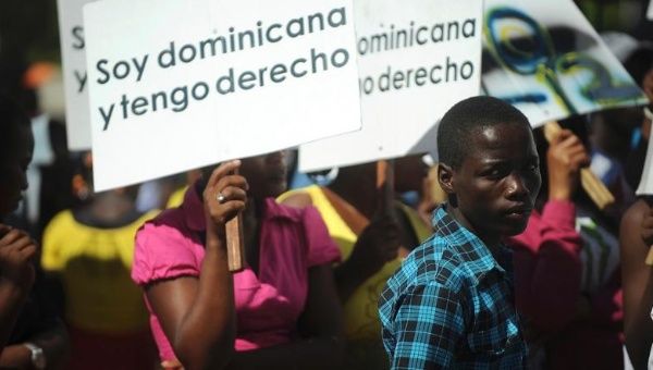 Haitian-Dominicans carry signs saying 