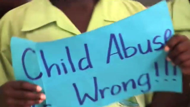 Child carries placard denouncing corporal punishment