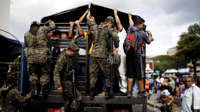 Soldiers board an army truck used for public transportation during a suspension of public transport services in San Salvador, El Salvador July 28, 2015.