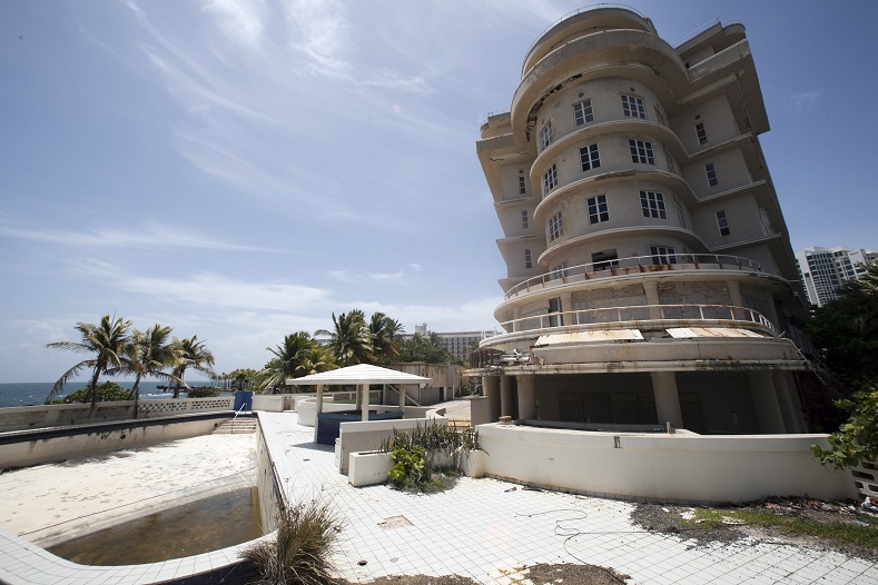 A view of the empty swimming pool and the outside of the luxury Normandie Hotel, closed since 2008, in San Juan, Puerto Rico, July 18, 2015.
