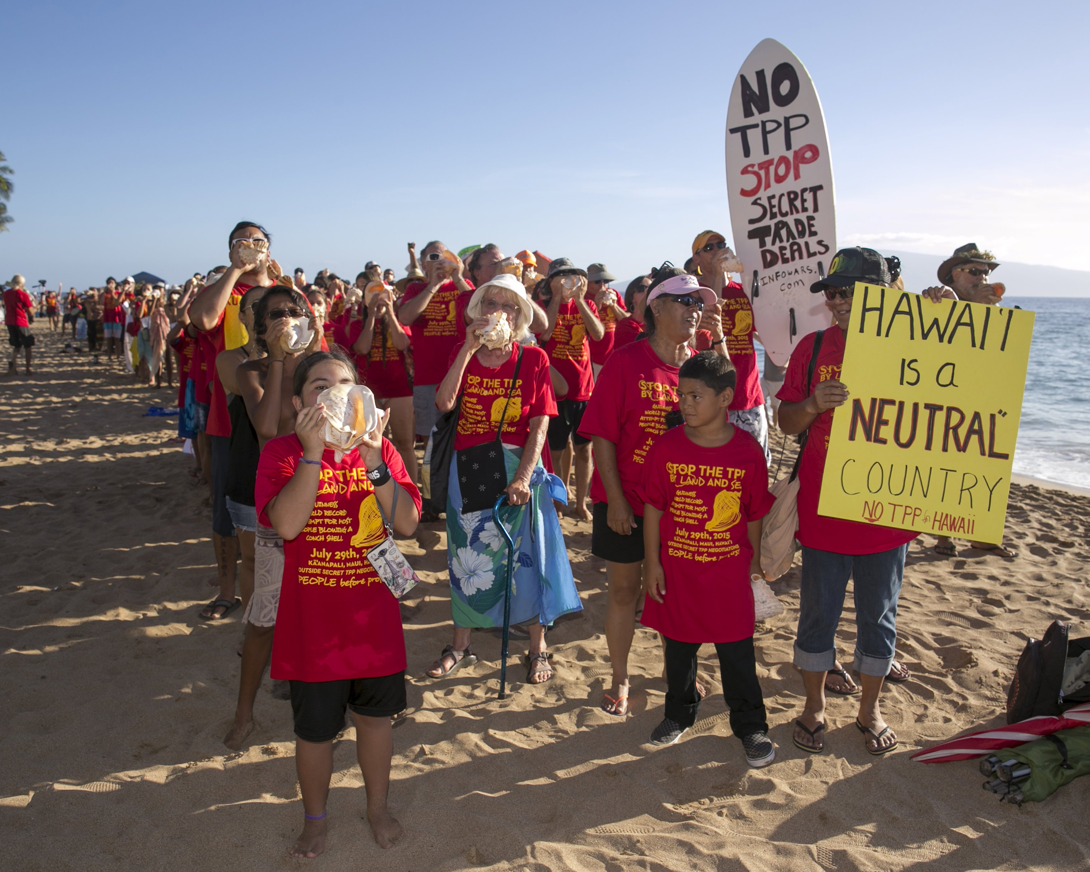 Protestors gather on the beach near the hotel where the Trans-Pacific Partnership (TPP) meeting is being held in Lahaina, Maui, Hawaii July 29, 2015.