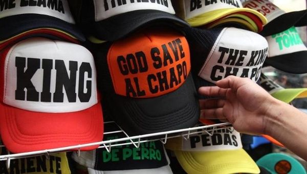Hats sporting phrases alluding to escaped drug lord Joaquin El Chapo Guzman for sale in Mexico City, July 23, 2015.
