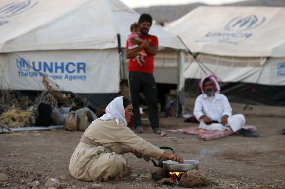 Displaced people from the minority Yazidi sect, who fled the violence in the Iraqi town of Sinjar, at Bajed Kadal refugee camp, Aug. 15, 2014.