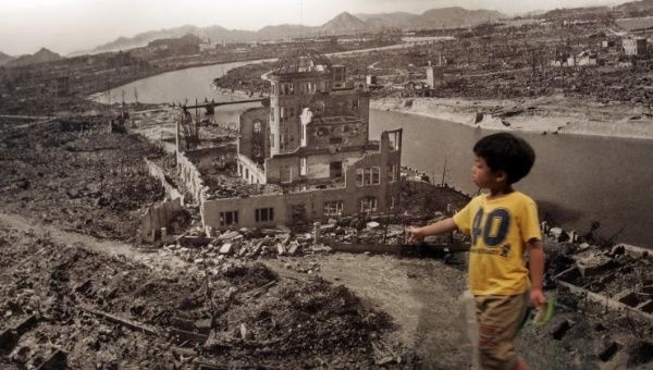 A boy looks at a huge photograph showing Hiroshima city after the 1945 atomic bombing, at the Hiroshima Peace Memorial Museum, Japan August 6, 2007.