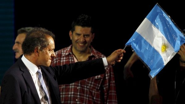 Daniel Scioli, Buenos Aires' province governor and presidential candidate, waves an Argentine national flag in Buenos Aires, early August 10, 2015. 