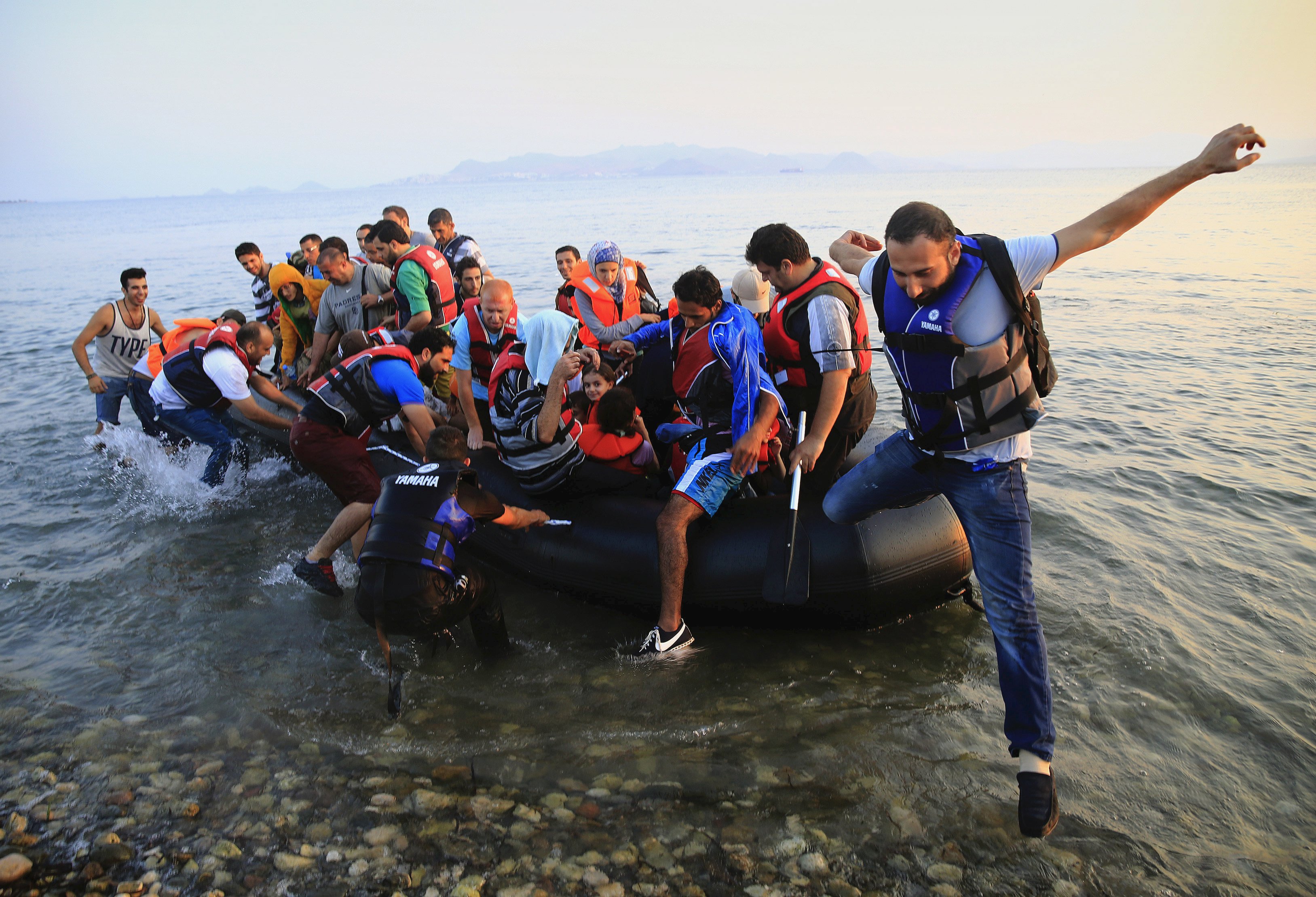 Syrian refugees arrive at a beach on the Greek island of Kos, August 11, 2015.