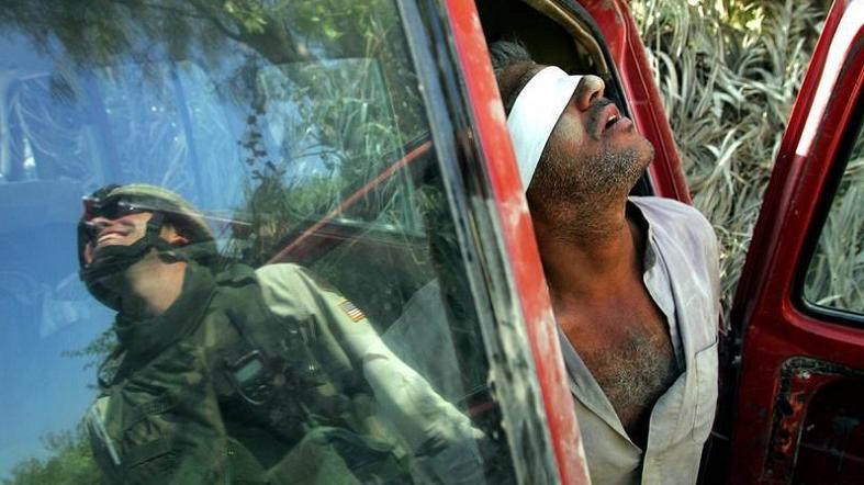 An Iraqi man suspected of having explosives in his car is held after being arrested by the U.S army near Baquba, Iraq.