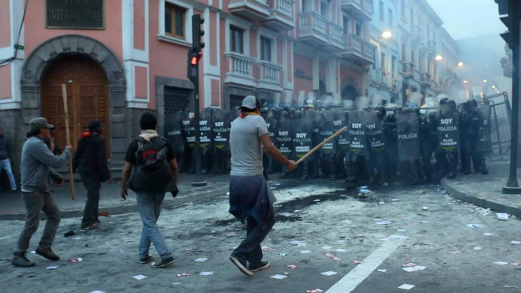 Opposition protestors clash with peaceful police officers during a protest in Quito, Ecuador.
