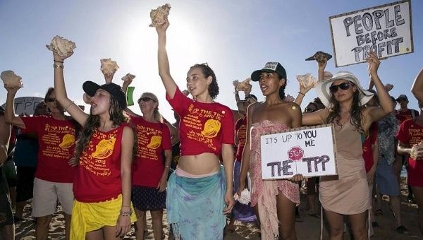 Protesters campaign against the Trans-Pacific Partnership in Hawaii near a hotel where the trade negotiations are taking place.