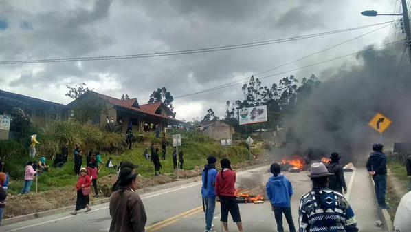 Protesters burn tires on a road to impede traffic, police who arrived to clear the roadblock were met with violence, Loja, Ecuador, Aug. 18, 2015.