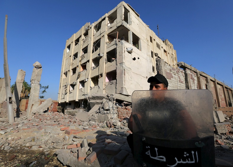 A security official guards the site of a bomb blast at a state security building in Shubra Al-Khaima, on the outskirts of Cairo, Aug. 20, 2015