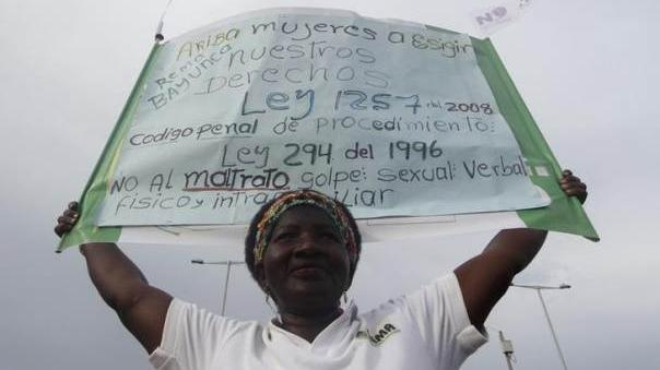 Demonstrator in Colombia holds a banner in support of Colombia's new anti-femicide bill that was passed in June, 2015.