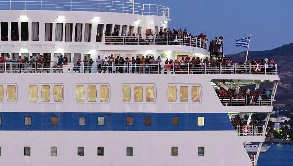 A passenger ship carrying Syrian migrants sets sail from the Greek island of Kos on Wednesday.
