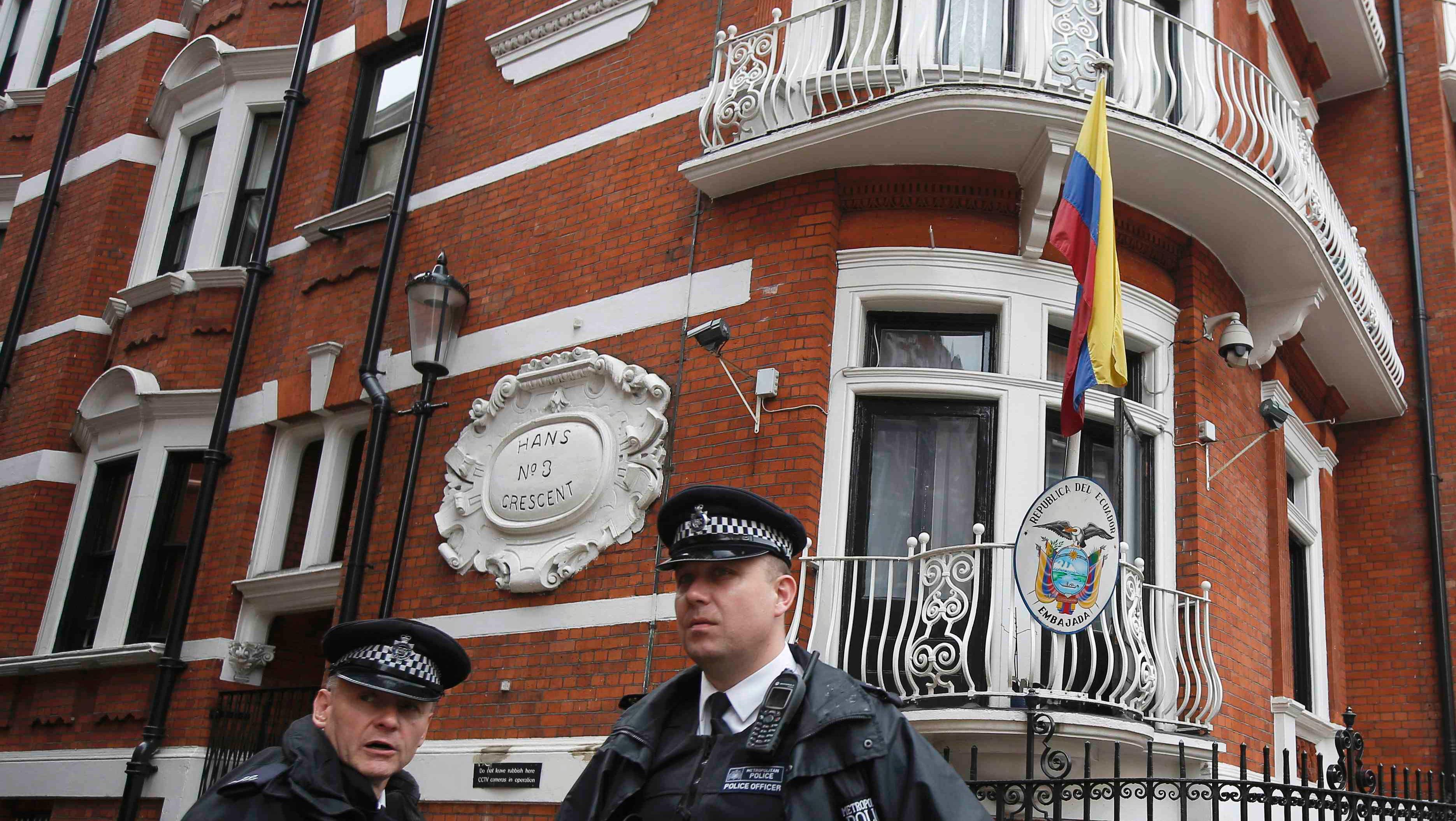Police officers stand outside the Ecuadorean embassy in London August 13, 2015.