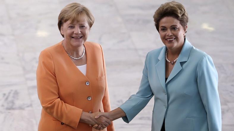German Chancellor Angela Merkel and Brazilian President Dilma Rousseff shake hands upon Merkel's arrival to Brasilia, August 20, 2015.