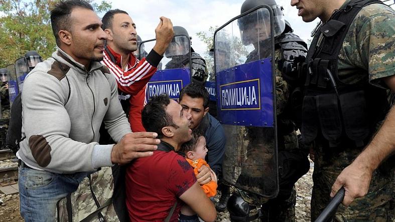 Migrants confront Macedonian police during clashes at the Greek-Macedonian border, August 21, 2015.