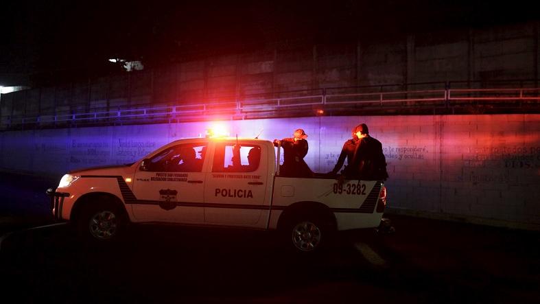 A patrol car is stopped near a prison where 14 members of the Barrio 18 group were killed in Quezaltepeque, El Salvador August 22, 2015.
