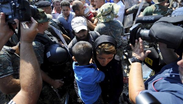 Police allow people to trickle through the Macedonia-Greece border Aug 24, 2015. 