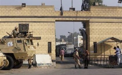 Egyptian army soldiers guard with armoured personnel carriers (APC) in front of the main gate of Torah prison on the outskirts of Cairo, Aug. 22, 2013.