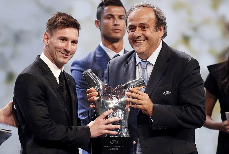 Barcelona's Lionel Messi (L) receives from UEFA President Michel Platini the Best Player UEFA 2015 Award Aug. 27, 2015.