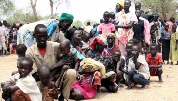 Residents displaced due to the recent fighting between government and rebel forces in the Upper Nile capital Malakal wait at a World Food Program outpost where thousands have taken shelter in Kuernyang Payam, South Sudan, May 2, 2015.