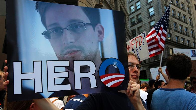 A demonstrator holds a sign with a photograph of former U.S. spy agency NSA contractor Edward Snowden