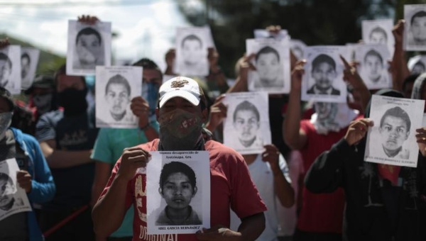 Protestors hold pictures of missing students outside the General Attorney building in Chilpancingo, in Guerrero, Oct. 7, 2014.
