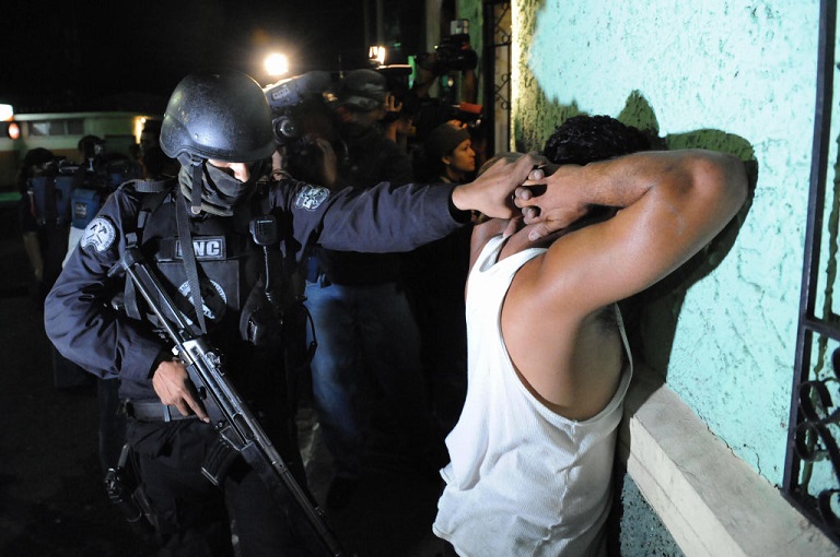 An elite police officer arrests an alleged member of the Mara Salvatrucha gang in San Juan Opico, La Libertad, El Salvador.