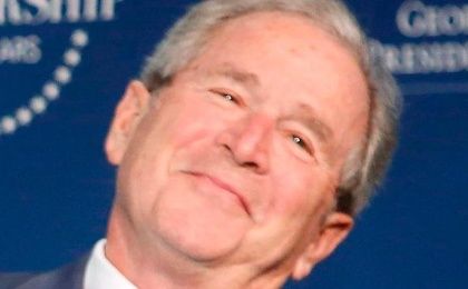 Former U.S. President George Bush has a mansion and is looking real happy.