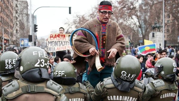 Mapuche protester engaging with police during a demonstration last July. 