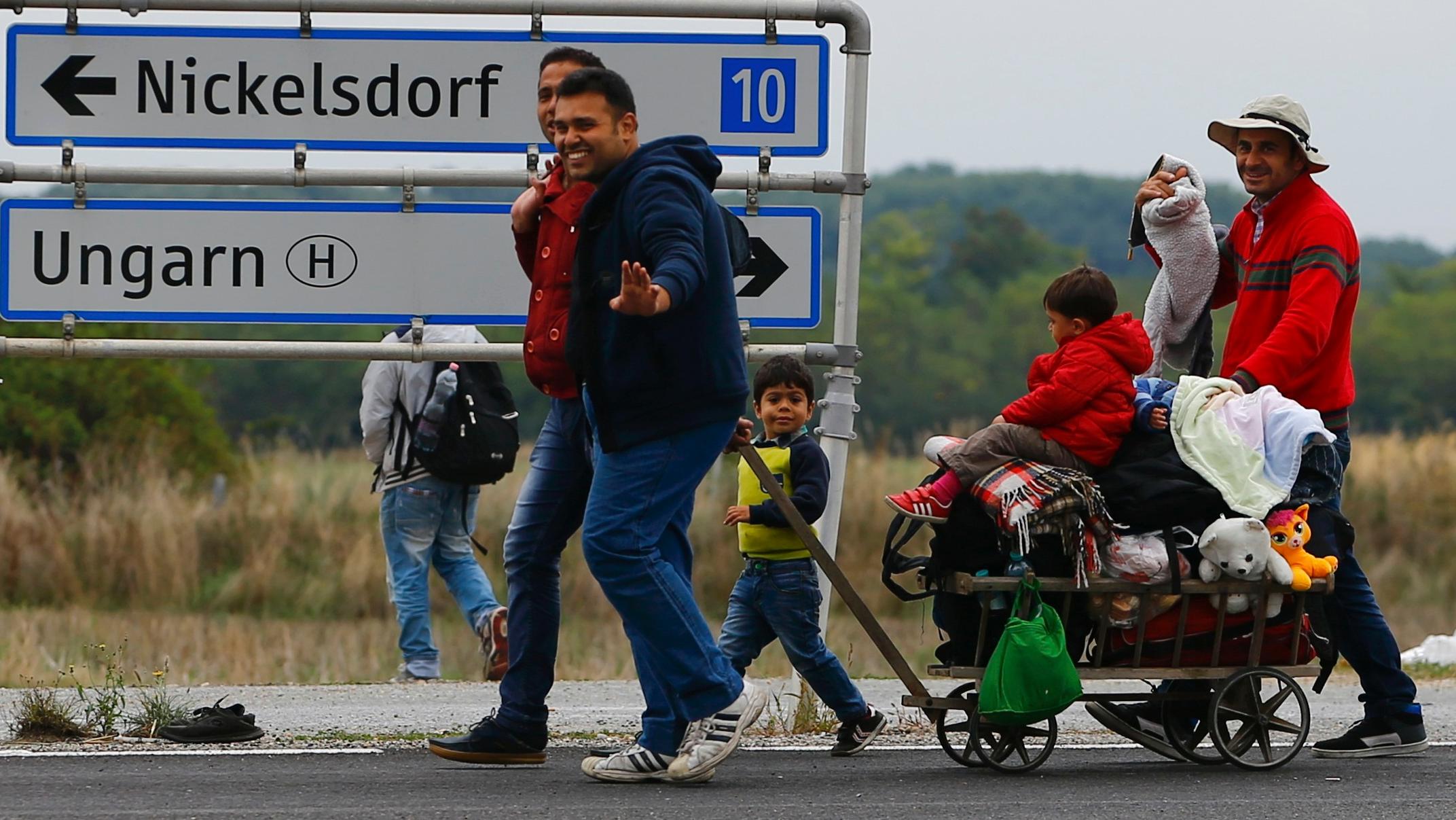 Migrants walk towards Nickelsdorf, Austria, September 11, 2015.