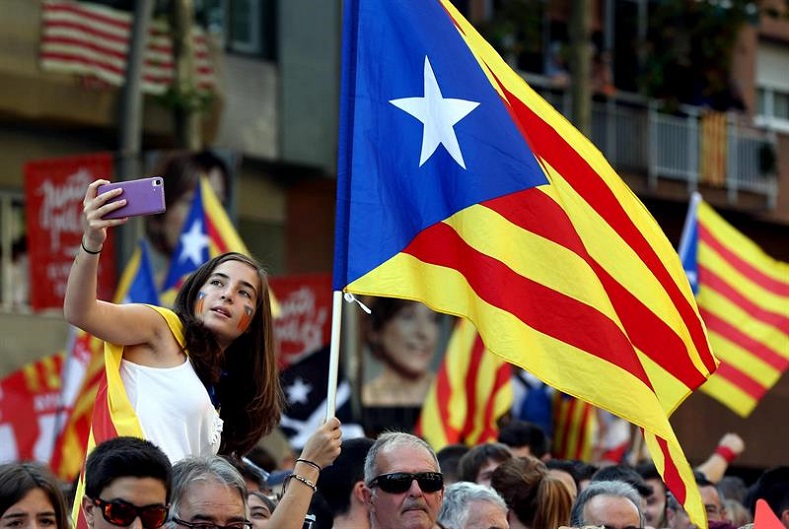 Pro-independence supporters wave Catalan flags. 