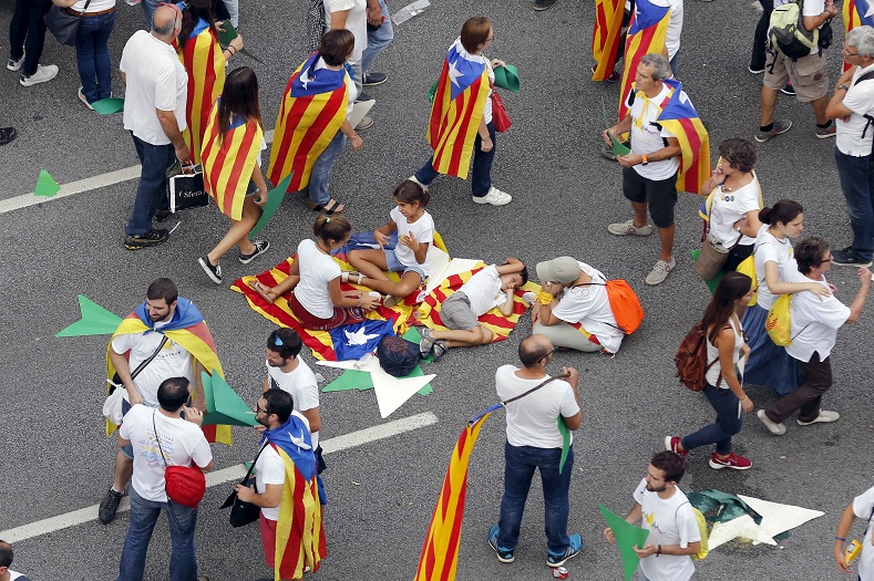 Catalan pro-independence supporters rest on the street and leave after taking part in a demonstration in support of an independent Catalan state.