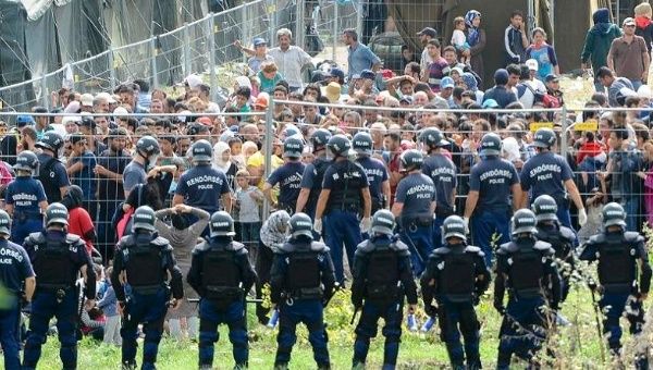 Riot police guard Hungary's Roszke refugee camp, which has become known for its poor conditions and alleged human rights violations. 