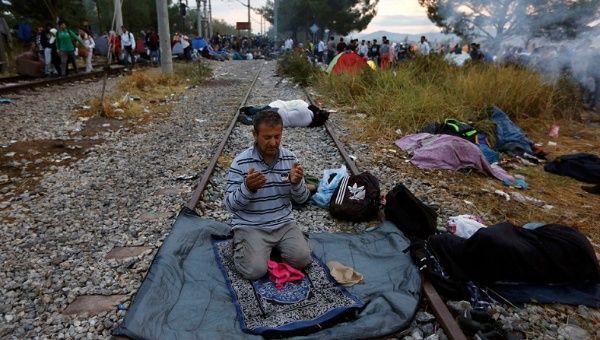 A Syrian refugee prays on a rail track at the Greek-Macedonian border, near the village of Idomeni, August 22, 2015