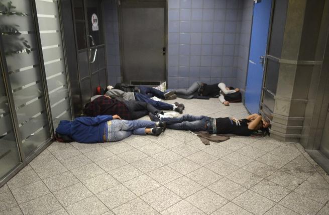 Migrants sleep at the central station on September 12, 2015 in Munich, southern Germany.
