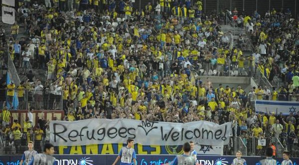 Maccabi Tel Aviv fans hold a banner saying 