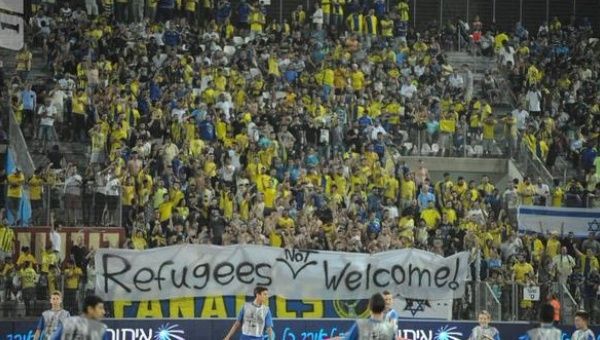 Maccabi Tel Aviv fans hold a banner saying 