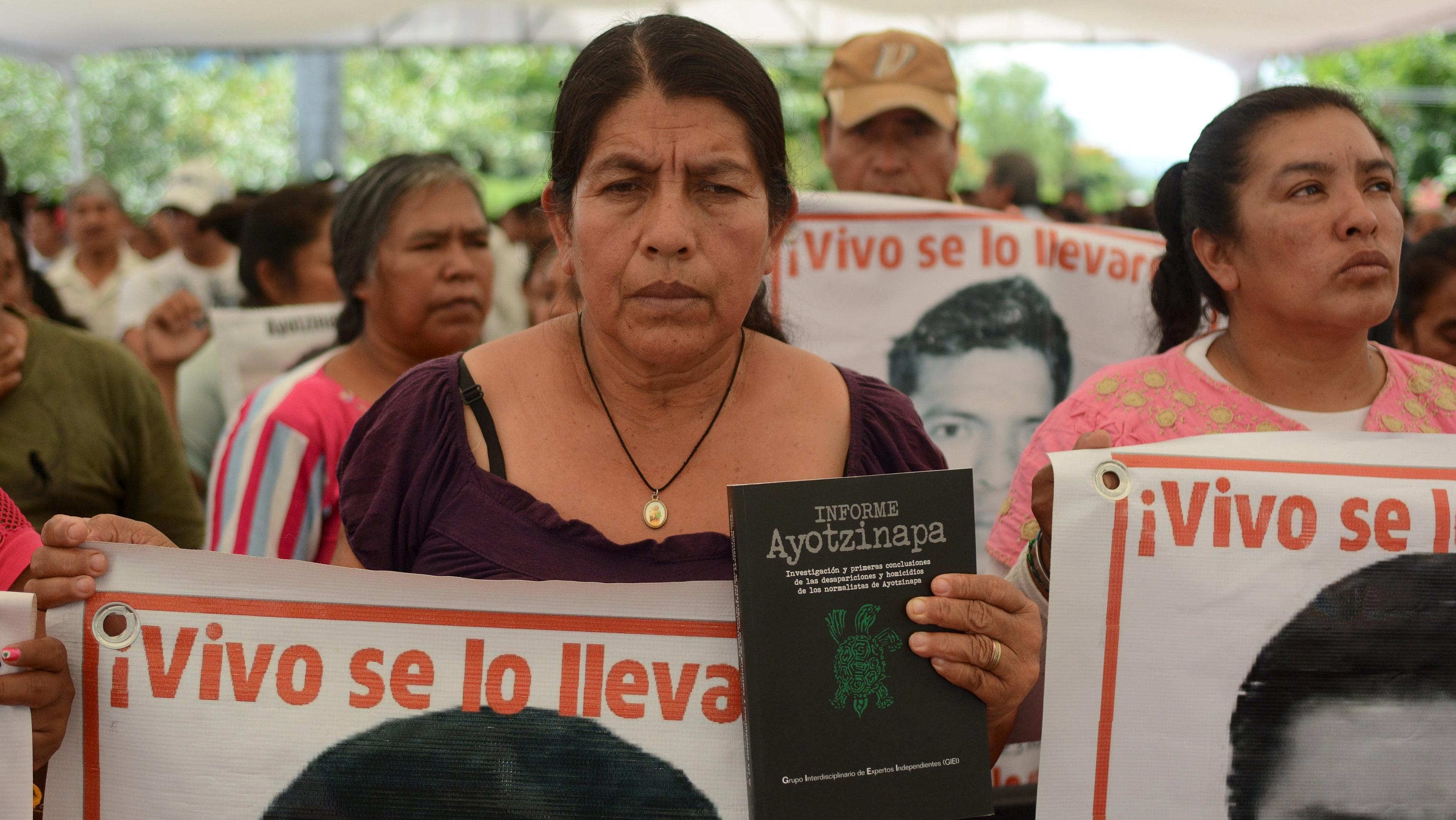 The relative of a missing student holds a copy of the report of the Inter-American Human Rights Commission (CIDH), during a meeting with members of the CIDH at the Ayotzinapa teachers' training college, in Tixtla, Mexico, September 8, 2015.