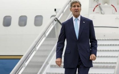 U.S. Secretary of State John Kerry steps off his plane after arriving at London' Stansted Airport for meetings on the ongoing Syrian crisis, on Friday, Sept. 18, 2015.